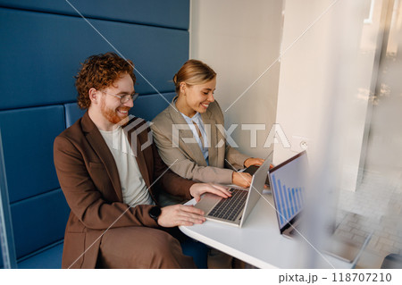 A Collaborative Work Environment Featuring Professionals Engaged with Laptops and Technology 118707210