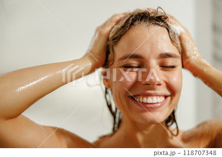 A Joyful Woman Delighting in an Invigorating Shower Experience That Uplifts Her Mood 118707348
