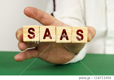 In the man's hand are cubes with the inscription - SaaS 118711058