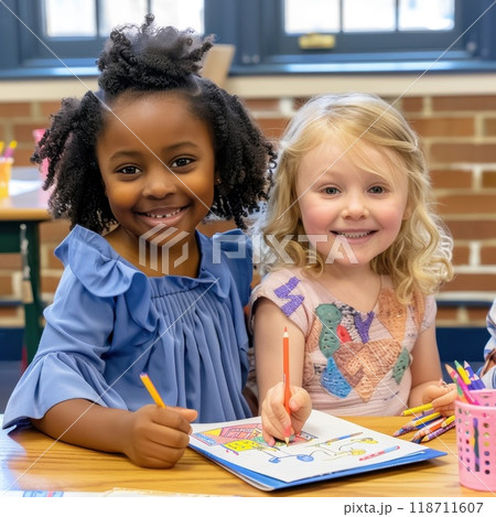 Two schoolgirls of different races paint at a creative art school 118711607