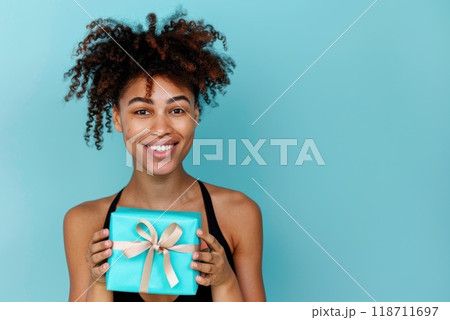 Happy birthday girl with a gift in her hands on a blue background 118711697