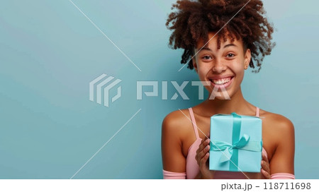Happy birthday girl with a gift in her hands on a blue background 118711698