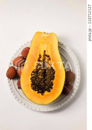 Half of a beautiful juicy ripe papaya and lychee Half of a beautiful juicy ripe papaya and lychee 118712127