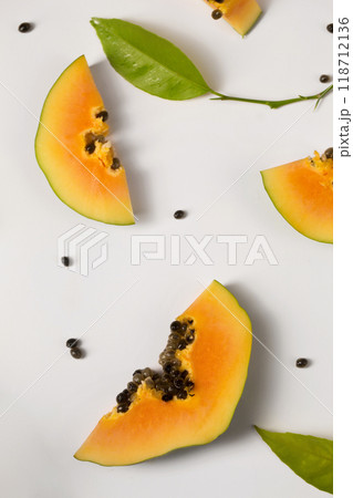 Fruit background made of pieces of papaya on a white background 118712136