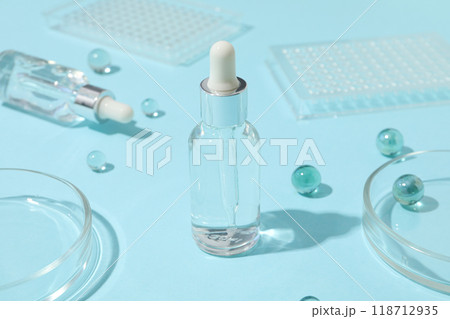 Transparent cosmetic bottles on a blue background 118712935