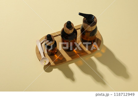 Cosmetic oil in a brown bottle on a light background 118712949