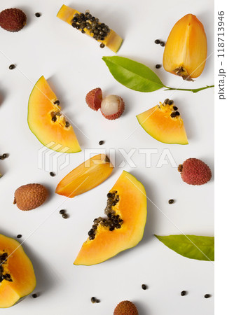 Fruit background made of pieces of ripe papaya, persimmon and litchi 118713946