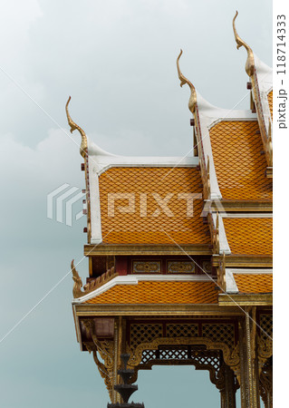 Golden temple roofs gleam against grey skies. Golden temple roofs gleam against grey skies. 118714333