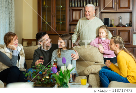 Happy large family gathered in parental home Happy large family gathered in parental home 118717472