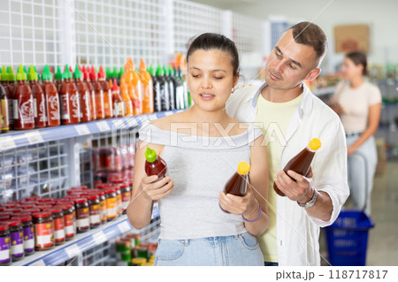 Married couple chooses spicy sauce in Chinese supermarket 118717817