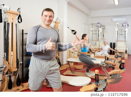 Adult man posing in pilates studio Adult man posing in pilates studio 118717896