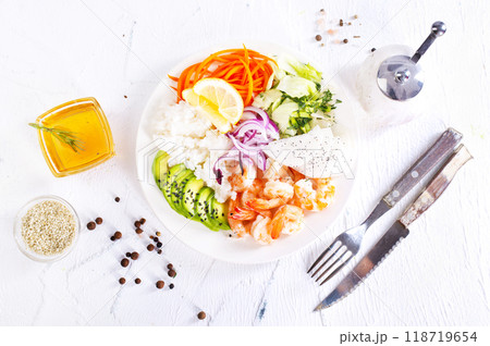Lunch diet - rice, shrimp, avocado in one plate on a light background Lunch diet - rice, shrimp, avocado in one plate on a light background 118719654