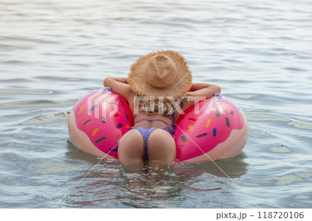 Beautiful woman enjoying the sea. Ass of a young sexy woman close-up. Back view of sexy ass. 118720106