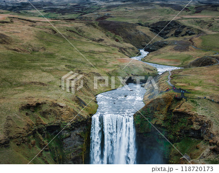 Impressively beautiful nature of Iceland during sunset. Skogafoss waterfall is one famous natural landmark and travel destination place of Iceland. Tourists ride horses near famouse waterfall. Impressively beautiful nature of Iceland during sunset. Skogafoss waterfall is one famous natural landmark and travel destination place of Iceland. Tourists ride horses near famouse waterfall. 118720173