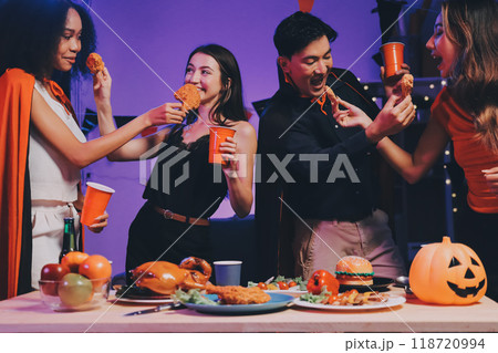 Joyful office Halloween party with coworkers in costumes, celebrating with drinks and laughter, fostering teamwork and festive spirit Joyful office Halloween party with coworkers in costumes, celebrating with drinks and laughter, fostering teamwork and festive spirit 118720994