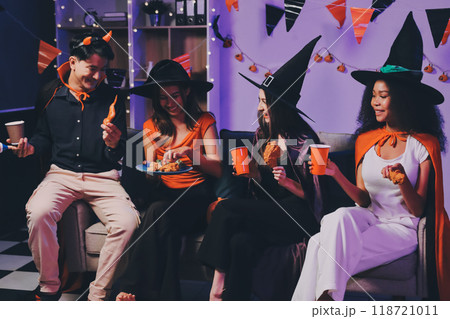 Joyful office Halloween party with coworkers in costumes, celebrating with drinks and laughter, fostering teamwork and festive spirit 118721011