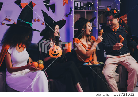Joyful office Halloween party with coworkers in costumes, celebrating with drinks and laughter, fostering teamwork and festive spirit 118721012