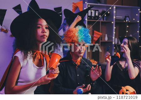 Joyful office Halloween party with coworkers in costumes, celebrating with drinks and laughter, fostering teamwork and festive spirit Joyful office Halloween party with coworkers in costumes, celebrating with drinks and laughter, fostering teamwork and festive spirit 118721019