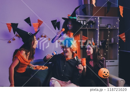 Joyful office Halloween party with coworkers in costumes, celebrating with drinks and laughter, fostering teamwork and festive spirit Joyful office Halloween party with coworkers in costumes, celebrating with drinks and laughter, fostering teamwork and festive spirit 118721020