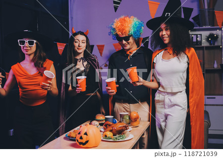 Joyful office Halloween party with coworkers in costumes, celebrating with drinks and laughter, fostering teamwork and festive spirit Joyful office Halloween party with coworkers in costumes, celebrating with drinks and laughter, fostering teamwork and festive spirit 118721039