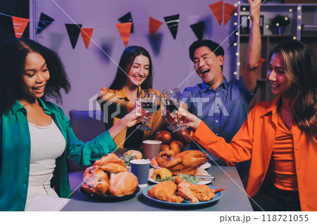 Joyful office Halloween party with coworkers in costumes, celebrating with drinks and laughter, fostering teamwork and festive spirit Joyful office Halloween party with coworkers in costumes, celebrating with drinks and laughter, fostering teamwork and festive spirit 118721055