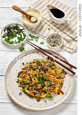 Japanese pancake with cabbage on a plate, top view 118721602