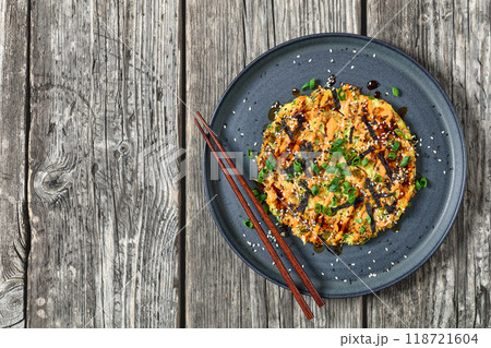 Japanese pancake with cabbage on a plate, top view 118721604