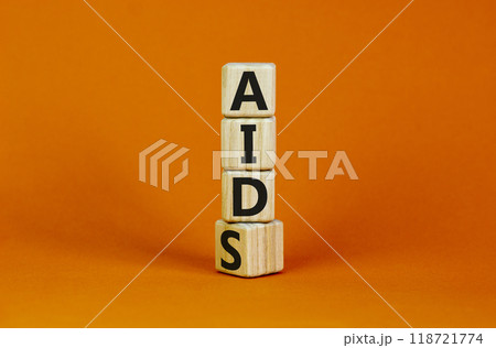 Symbol for helping people with aids, Acquired immunodeficiency syndrome. Turned a wooden cube with words aids aid. Beautiful orange background, copy space. Medical and aids aid concept. Symbol for helping people with aids, Acquired immunodeficiency syndrome. Turned a wooden cube with words aids aid. Beautiful orange background, copy space. Medical and aids aid concept. 118721774