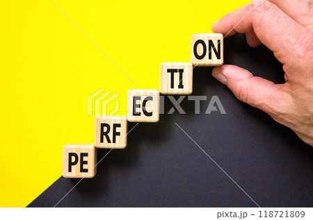 Perfection symbol. Concept word Perfection on beautiful wooden cubes. Beautiful yellow and black background. Businessman hand. Business perfection concept. Copy space. 118721809