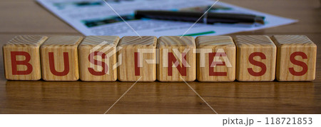 concept word business on cubes on a beautiful wooden table, pen and documents 118721853