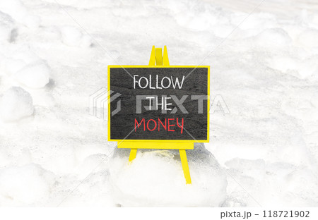 Follow the money symbol. Concept words Follow the money on beautiful black chalk blackboard. Beautiful white snow background. Business and follow the money concept. Copy space. 118721902