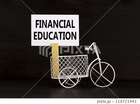 Financial education symbol. Concept words Financial education on beautiful white paper on wooden clothespin. Beautiful black background. Bike model. Business Financial education concept. Copy space. 118721943