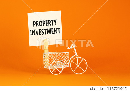 Property investment symbol. Concept words Property investment on beautiful white paper on wooden clothespin. Beautiful orange background. Bike model. Business Property investment concept. Copy space. Property investment symbol. Concept words Property investment on beautiful white paper on wooden clothespin. Beautiful orange background. Bike model. Business Property investment concept. Copy space. 118721945