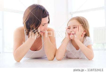 Mother with her little daughter girl luing on a floor in light room 118722411