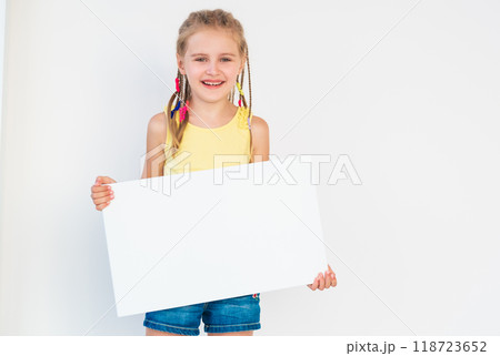 Little girl showing blank white canvas banner for advertising Little girl showing blank white canvas banner for advertising 118723652