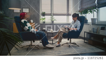 Therapy session in psychological office: teenage girl on consultation Therapy session in psychological office: teenage girl on consultation 118725261