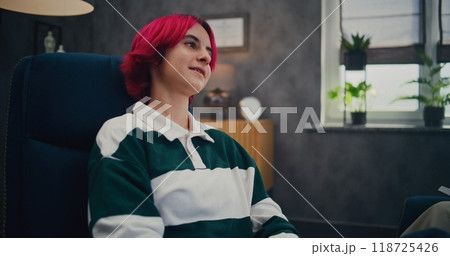 Pink-haired teen girl with braces on consultation with psychologist Pink-haired teen girl with braces on consultation with psychologist 118725426