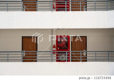 fire hose and fire extinguisher in a hotel corridor 118725898