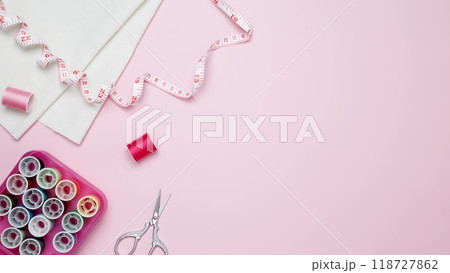 Composition with various threads and sewing accessories on pink background. Top view, copy space 118727862