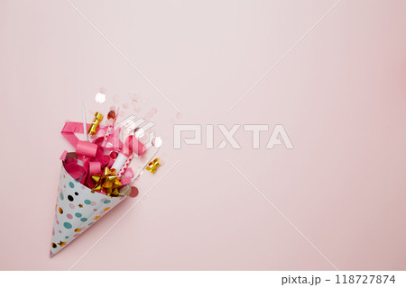 Party hat for birthday with colorful balloons, party hats, candles, and confetti. Concept of festive birthday celebrations Party hat for birthday with colorful balloons, party hats, candles, and confetti. Concept of festive birthday celebrations 118727874