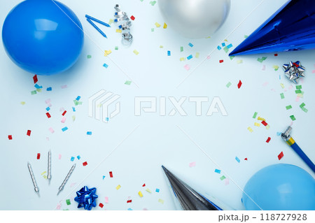 Birthday attributes colorful balloons, party hats, candles, and confetti. Concept of festive birthday celebrations 118727928