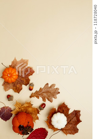 Autumn composition with maple leaves, decorative pumpkins and candles. Top view. Copy space 118728040