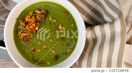 RECIPE FOR LEEK AND POTATO SOUP WITH GOLDEN PINE NUTS AND DRIED FLOWERS 118728648