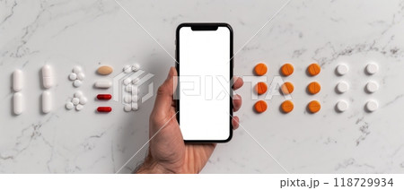 Black and colorful pills surrounding a smartphone on a white background. 118729934