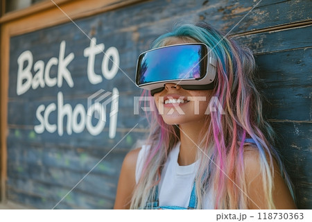 Beautiful girl with multi-colored hair in virtual reality glasses - Inscription on board Back to school Beautiful girl with multi-colored hair in virtual reality glasses - Inscription on board Back to school 118730363