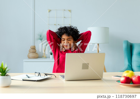 African american girl at home office relaxing stretching hands and body taking break from work on laptop. Joyful young woman freelancer businesswoman happy after work done satisfied by good result 118730697