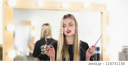 Young lovely professional master holding tools for work and posing Young lovely professional master holding tools for work and posing 118731138