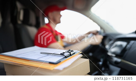 Docs on box and smiling courier deliver packages to people on car 118731165