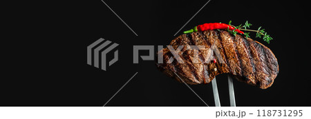 grilled steak beef meat on a dark background. Long banner format. copy space grilled steak beef meat on a dark background. Long banner format. copy space 118731295