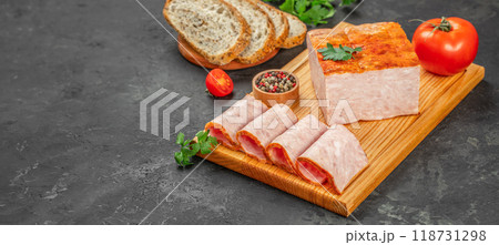 slices ham with aromatic spices on a wooden board, top view. copy space slices ham with aromatic spices on a wooden board, top view. copy space 118731298